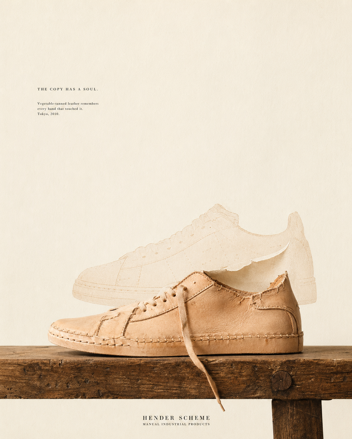 A pair of natural vegetable-tanned leather sneakers — Hender Scheme MIP series — resting on a weathered wooden plank