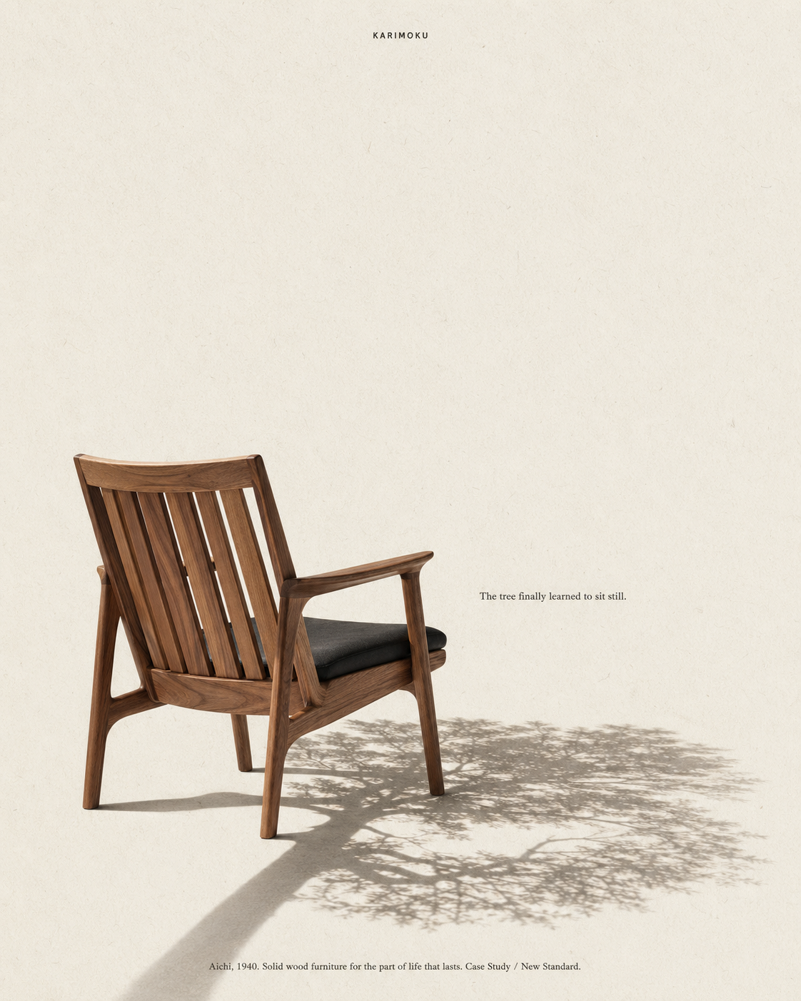 A solid-wood Karimoku lounge chair with a black cushion, casting a long shadow across a cream wall